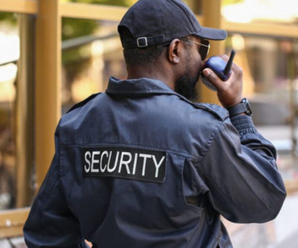 Security guard speaking into a radio
