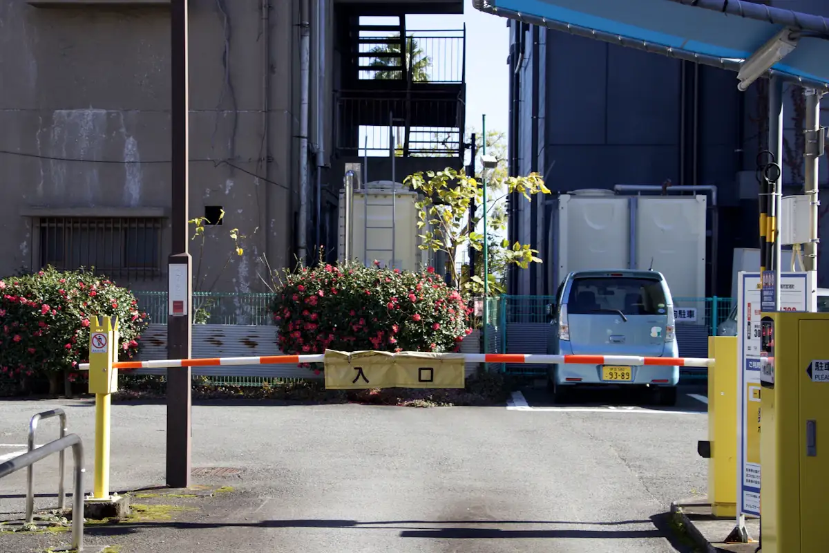 Vehicle waiting at a boom barrier on an estate entrance